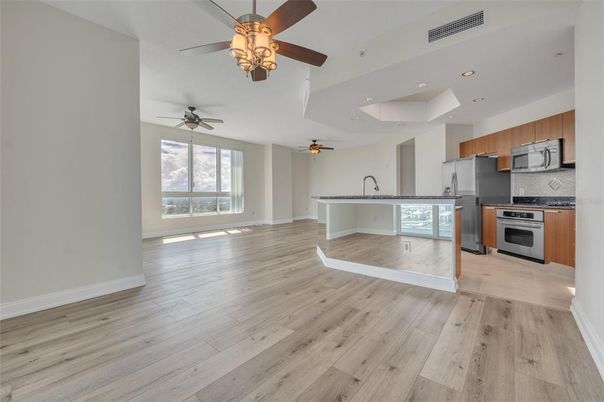 Empty room, Interior, Kitchen, Recessed Lighting, Stainless Steel Appliances, Wood Texture Flooring