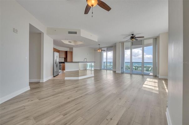 Empty room, Interior, Kitchen, Recessed Lighting, Stainless Steel Appliances, Wood Texture Flooring