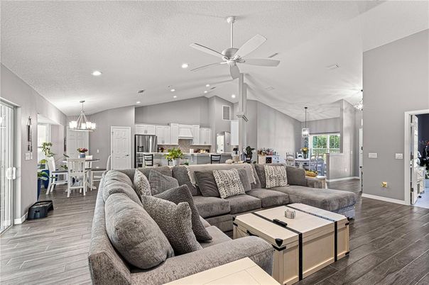 Chandelier, Dining room, Interior, Kitchen, Living room, Pendant Lights, Recessed Lighting, Stainless Steel Appliances, Wood Texture Flooring