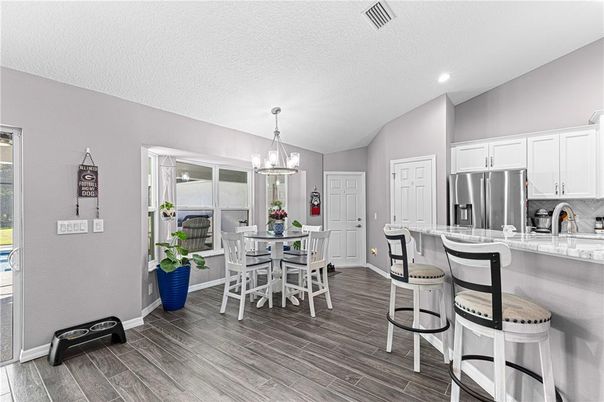 Chandelier, Dining room, Interior, Kitchen, Pendant Lights, Recessed Lighting, Stainless Steel Appliances, Wood Texture Flooring