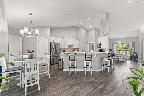 Chandelier, Dining room, Interior, Kitchen, Pendant Lights, Recessed Lighting, Stainless Steel Appliances, Wood Texture Flooring