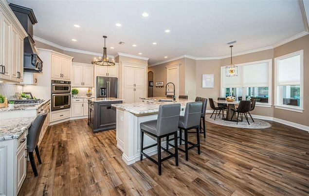 Chandelier, Dining room, Interior, Kitchen, Pendant Lights, Recessed Lighting, Stainless Steel Appliances, Wood Texture Flooring