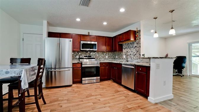 Dining room, Interior, Kitchen, Pendant Lights, Recessed Lighting, Stainless Steel Appliances, Wood Texture Flooring