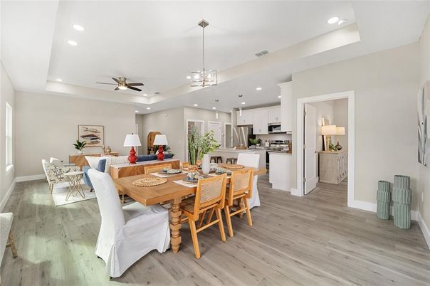 Chandelier, Dining room, Interior, Kitchen, Living room, Pendant Lights, Recessed Lighting, Stainless Steel Appliances, Wood Texture Flooring