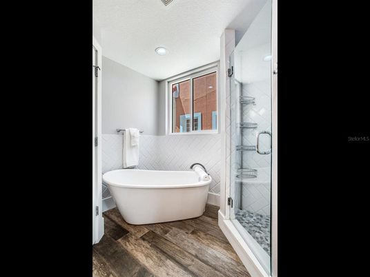 Bathroom, Free Standing Baths, Glass Shower, Interior, Recessed Lighting, Wood Texture Flooring