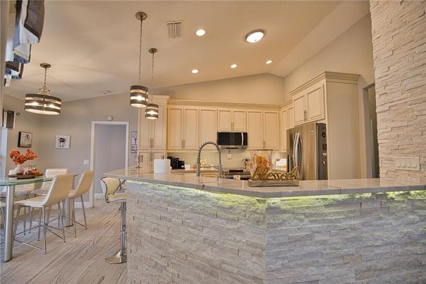 Dining room, Interior, Kitchen, Pendant Lights, Recessed Lighting, Stainless Steel Appliances, Stone Walls, Wood Texture Flooring