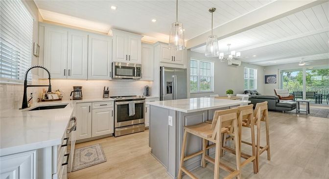 Chandelier, Interior, Kitchen, Living room, Pendant Lights, Recessed Lighting, Stainless Steel Appliances, Wood Texture Flooring
