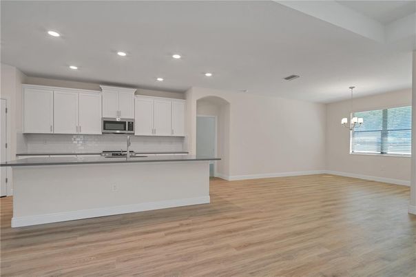 Empty room, Interior, Kitchen, Pendant Lights, Recessed Lighting, Stainless Steel Appliances, Wood Texture Flooring