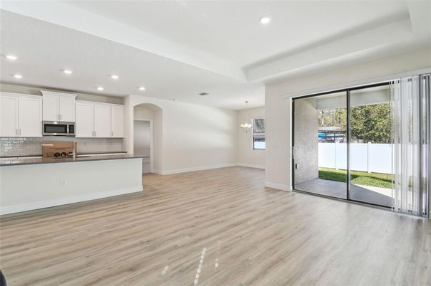 Chandelier, Empty room, Interior, Kitchen, Pendant Lights, Recessed Lighting, Stainless Steel Appliances, Wood Texture Flooring
