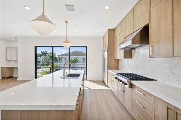 Interior, Kitchen, Marble Walls, Pendant Lights, Recessed Lighting, Stainless Steel Appliances, Wood Texture Flooring