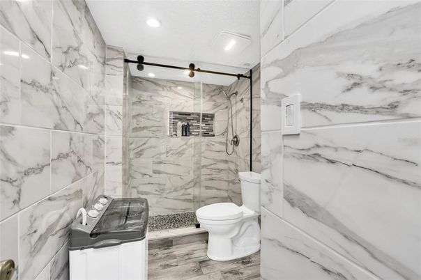 Bathroom, Glass Shower, Interior, Marble Walls, Recessed Lighting, Wood Texture Flooring