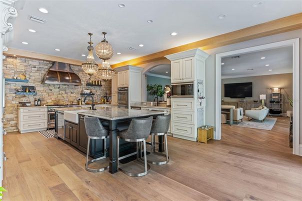 Chandelier, Interior, Kitchen, Living room, Recessed Lighting, Stainless Steel Appliances, Stone Walls, Wood Texture Flooring