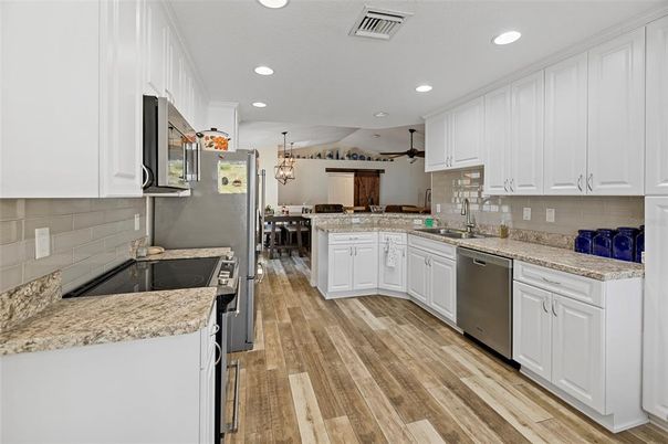 Dining room, Interior, Kitchen, Pendant Lights, Recessed Lighting, Stainless Steel Appliances, Wood Texture Flooring