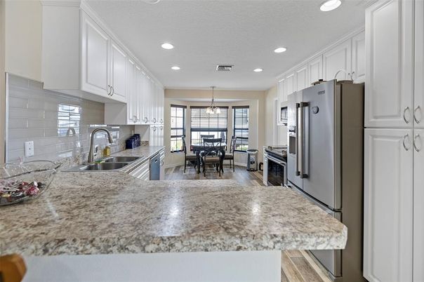 Dining room, Interior, Kitchen, Pendant Lights, Recessed Lighting, Stainless Steel Appliances, Wood Texture Flooring