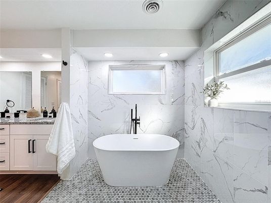 Bathroom, Free Standing Baths, Interior, Marble Walls, Recessed Lighting, Wood Texture Flooring