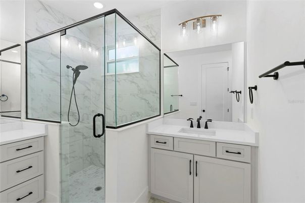 Bathroom, Dual Sink Vanities, Glass Shower, Interior, Marble Walls, Recessed Lighting