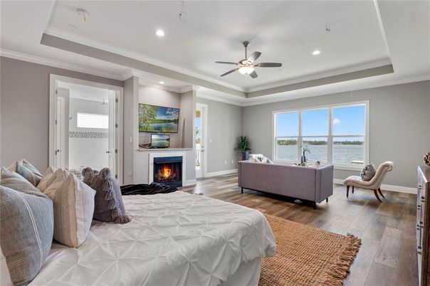 Bedroom, Fireplace, Interior, Living room, Recessed Lighting, Water, Wood Texture Flooring
