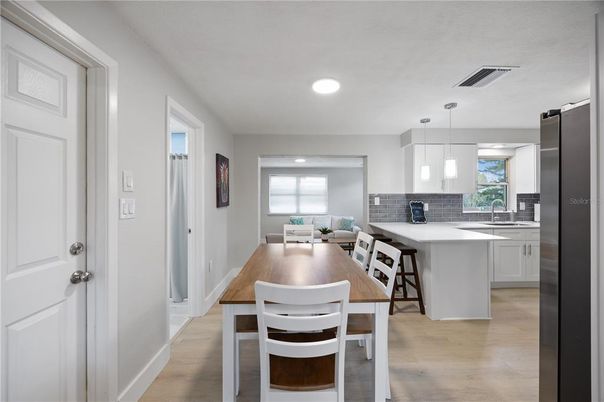 Dining room, Interior, Kitchen, Pendant Lights, Recessed Lighting, Stainless Steel Appliances, Wood Texture Flooring