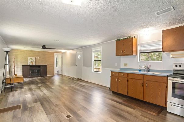 Fireplace, Interior, Kitchen, Stainless Steel Appliances, Wood Texture Flooring