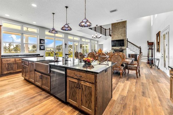 Chandelier, Dining room, Fireplace, Interior, Kitchen, Living room, Pendant Lights, Recessed Lighting, Stone Walls, Wood Texture Flooring