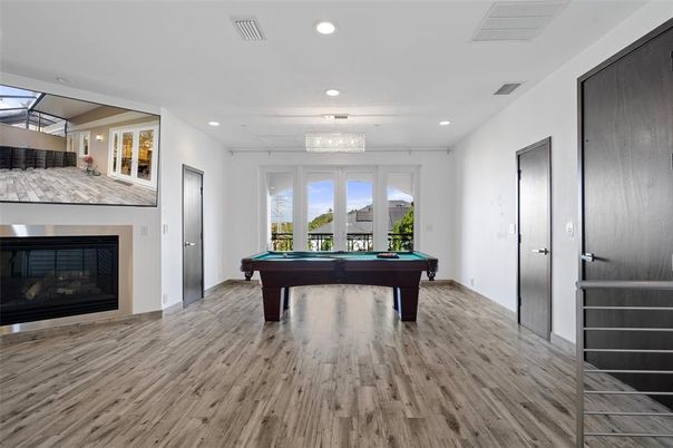 Billiard Table, Chandelier, Fireplace, Game Room, Interior, Recessed Lighting, Wood Texture Flooring
