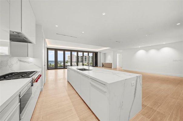Interior, Kitchen, Marble Walls, Recessed Lighting, Stainless Steel Appliances, Wood Texture Flooring