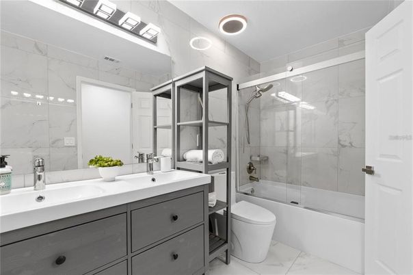 Bathroom, Dual Sink Vanities, Glass Shower, Interior, Marble, Marble Walls, Recessed Lighting