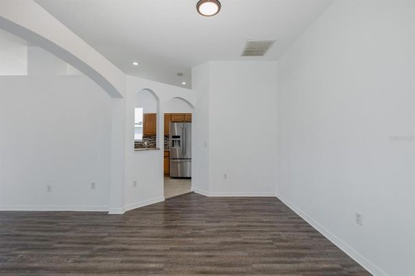 Empty room, Interior, Kitchen, Recessed Lighting, Stainless Steel Appliances, Wood Texture Flooring