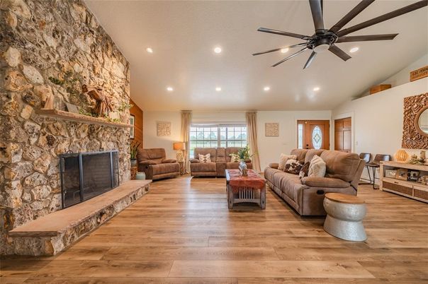 Fireplace, Interior, Living room, Recessed Lighting, Stone Walls, Wood Texture Flooring