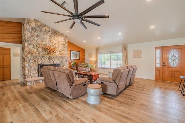 Fireplace, Interior, Living room, Recessed Lighting, Stone Walls, Wood Texture Flooring