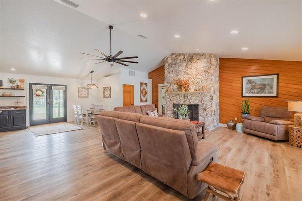 Dining room, Fireplace, Interior, Living room, Pendant Lights, Recessed Lighting, Stone Walls, Wood Texture Flooring, Wooden Walls