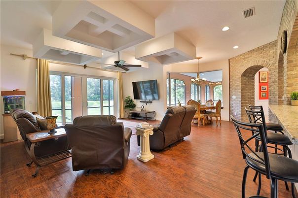 Chandelier, Dining room, Interior, Living room, Recessed Lighting, Stone Walls, Wood Texture Flooring