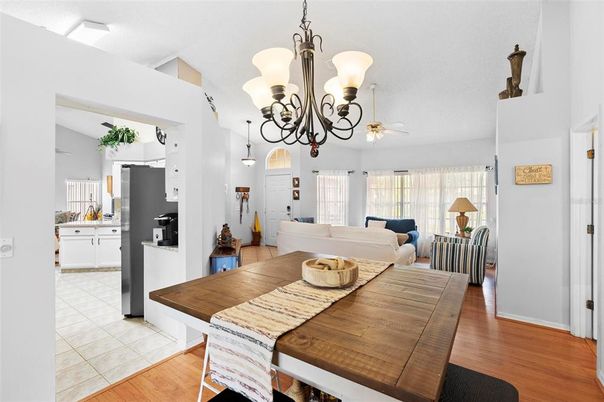 Chandelier, Dining room, Interior, Kitchen, Living room, Pendant Lights, Stainless Steel Appliances, Wood Texture Flooring