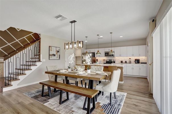 Dining room, Interior, Kitchen, Pendant Lights, Recessed Lighting, Stainless Steel Appliances, Wood Texture Flooring
