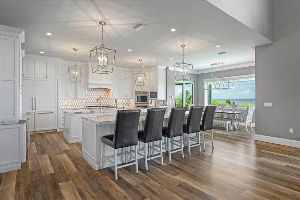 Chandelier, Dining room, Interior, Kitchen, Pendant Lights, Recessed Lighting, Stainless Steel Appliances, Wood Texture Flooring