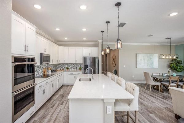 Dining room, Interior, Kitchen, Pendant Lights, Recessed Lighting, Stainless Steel Appliances, Wood Texture Flooring