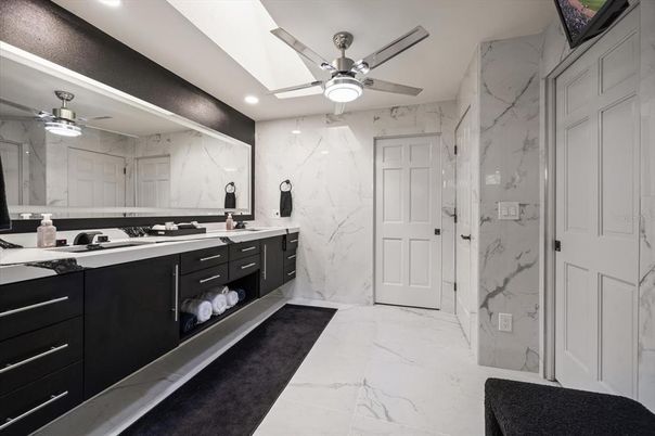 Bathroom, Dual Sink Vanities, Glass Shower, Interior, Marble, Marble Walls, Recessed Lighting