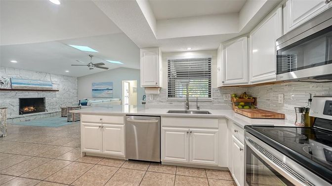Fireplace, Interior, Kitchen, Recessed Lighting, Stainless Steel Appliances, Stone Walls