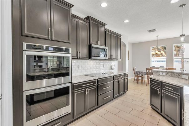 Chandelier, Dining room, Interior, Kitchen, Pendant Lights, Recessed Lighting, Stainless Steel Appliances, Wood Texture Flooring
