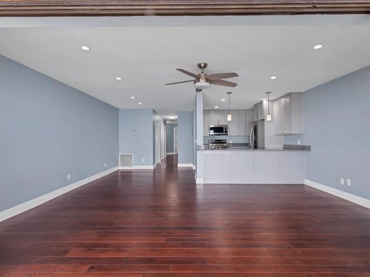 Empty room, Interior, Kitchen, Pendant Lights, Recessed Lighting, Stainless Steel Appliances, Wood Texture Flooring
