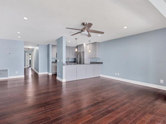Empty room, Interior, Kitchen, Pendant Lights, Recessed Lighting, Stainless Steel Appliances, Wood Texture Flooring