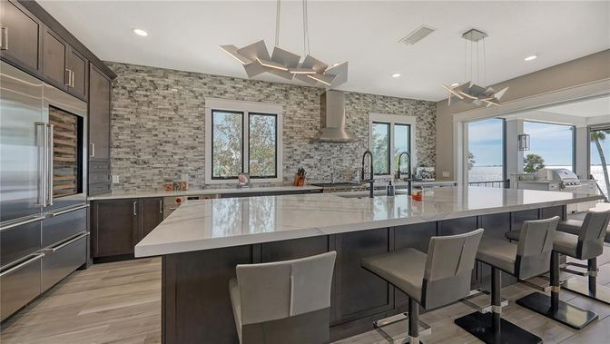 Interior, Kitchen, Pendant Lights, Recessed Lighting, Stainless Steel Appliances, Stone Walls, Wood Texture Flooring