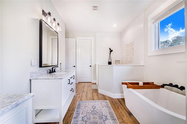 Bathroom, Dual Sink Vanities, Free Standing Baths, Interior, Recessed Lighting, Wood Texture Flooring