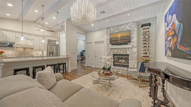 Chandelier, Fireplace, Interior, Kitchen, Living room, Pendant Lights, Recessed Lighting, Stainless Steel Appliances, Wood Texture Flooring