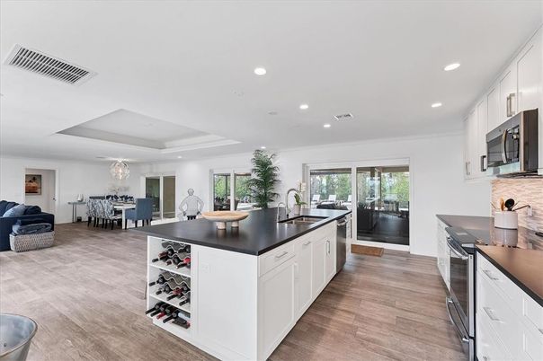 Chandelier, Dining room, Interior, Kitchen, Recessed Lighting, Stainless Steel Appliances, Wood Texture Flooring