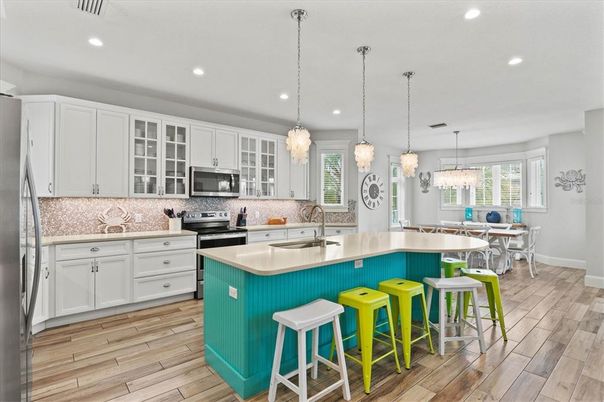 Chandelier, Dining room, Interior, Kitchen, Pendant Lights, Recessed Lighting, Stainless Steel Appliances, Wood Texture Flooring