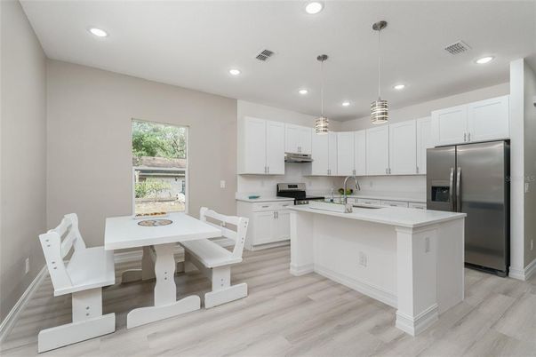 Dining room, Interior, Kitchen, Pendant Lights, Recessed Lighting, Stainless Steel Appliances, Wood Texture Flooring