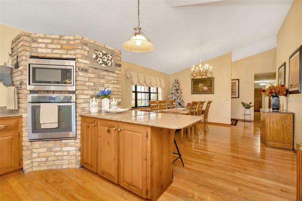 Chandelier, Dining room, Fireplace, Interior, Pendant Lights, Stone Walls, Wood Texture Flooring