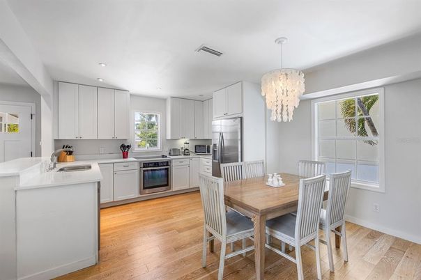 Chandelier, Dining room, Interior, Kitchen, Recessed Lighting, Stainless Steel Appliances, Wood Texture Flooring