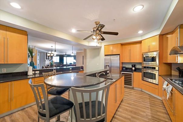 Chandelier, Dining room, Interior, Kitchen, Pendant Lights, Recessed Lighting, Stainless Steel Appliances, Wood Texture Flooring